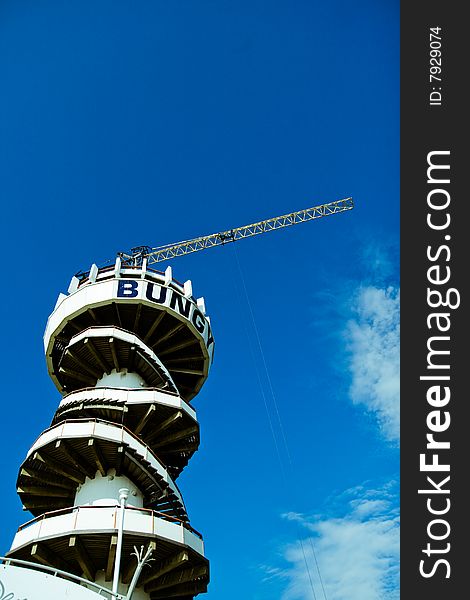 Image of a bungee jumping crane over blue sky. Image of a bungee jumping crane over blue sky.