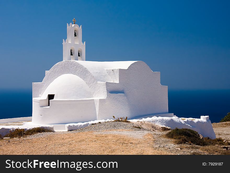 It's a lovely small greek church on the island of Santorini (Thira), located on top of a remote hill far from tourists. In the backgroud is the deep blue Aegian sea and the sky. It's a lovely small greek church on the island of Santorini (Thira), located on top of a remote hill far from tourists. In the backgroud is the deep blue Aegian sea and the sky.