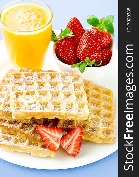 Tasty wafers with fresh strawberry and orange juice. Tasty wafers with fresh strawberry and orange juice