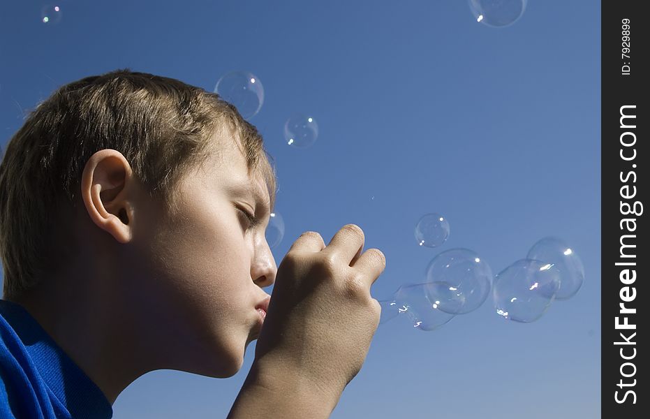 A boy blowing soap bubbles