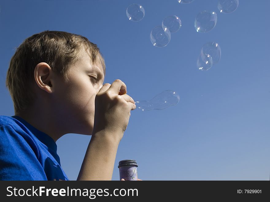 A boy blowing soap bubbles