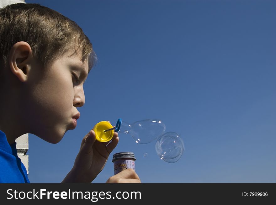 A boy blowing soap bubbles