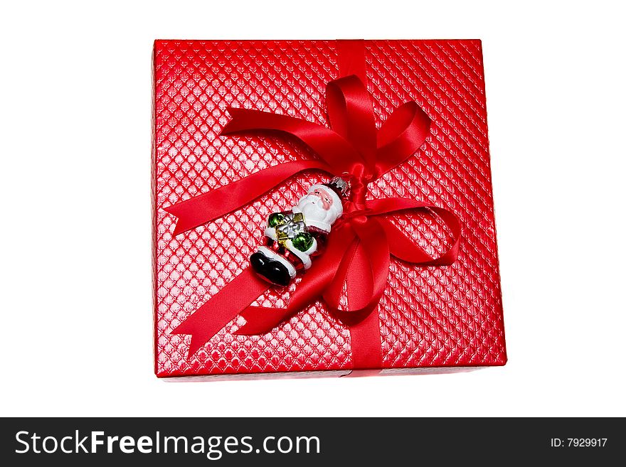 A nicely wrapped Christmas gift in red with santa claus on white background. A nicely wrapped Christmas gift in red with santa claus on white background