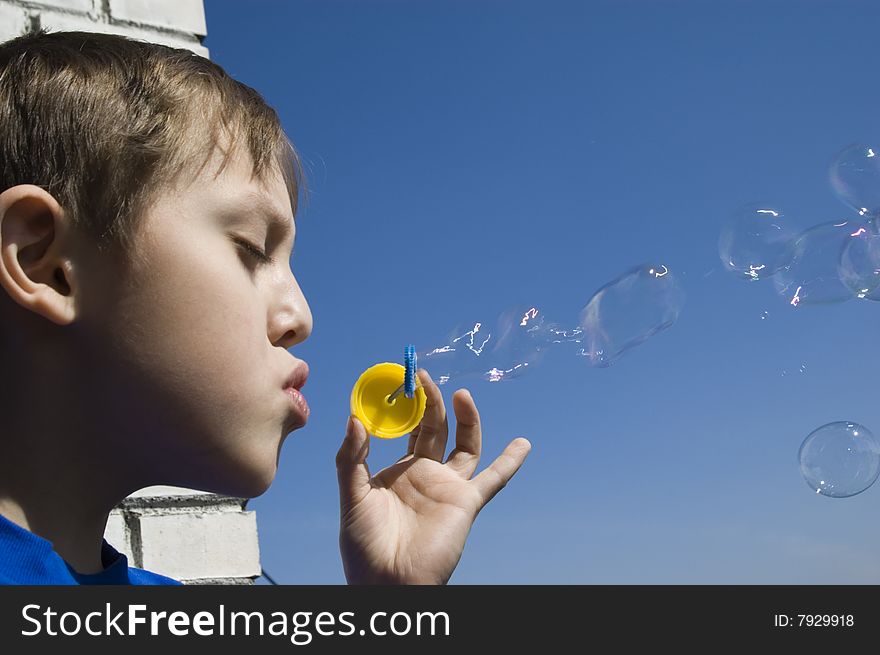 Boy Blowing Soap Bubbles