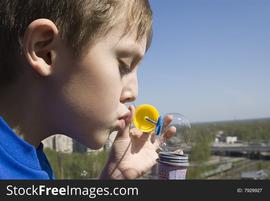 Boy Blowing Soap Bubbles