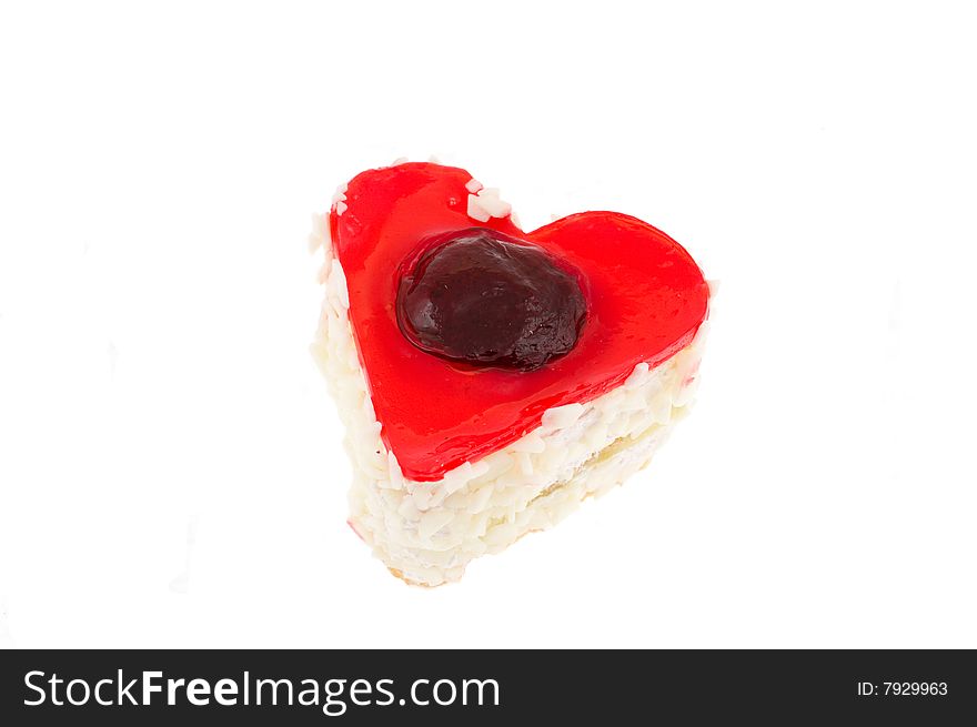 Cake in the form of heart in jelly with a strawberry in a coconut shaving on white
