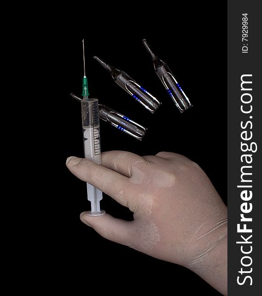 Syringe in a hand and three ampoules with a medicine isolated on a black. Syringe in a hand and three ampoules with a medicine isolated on a black