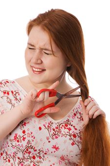 The Young Beautiful Woman Cuts Red Long Hair Royalty Free Stock Image