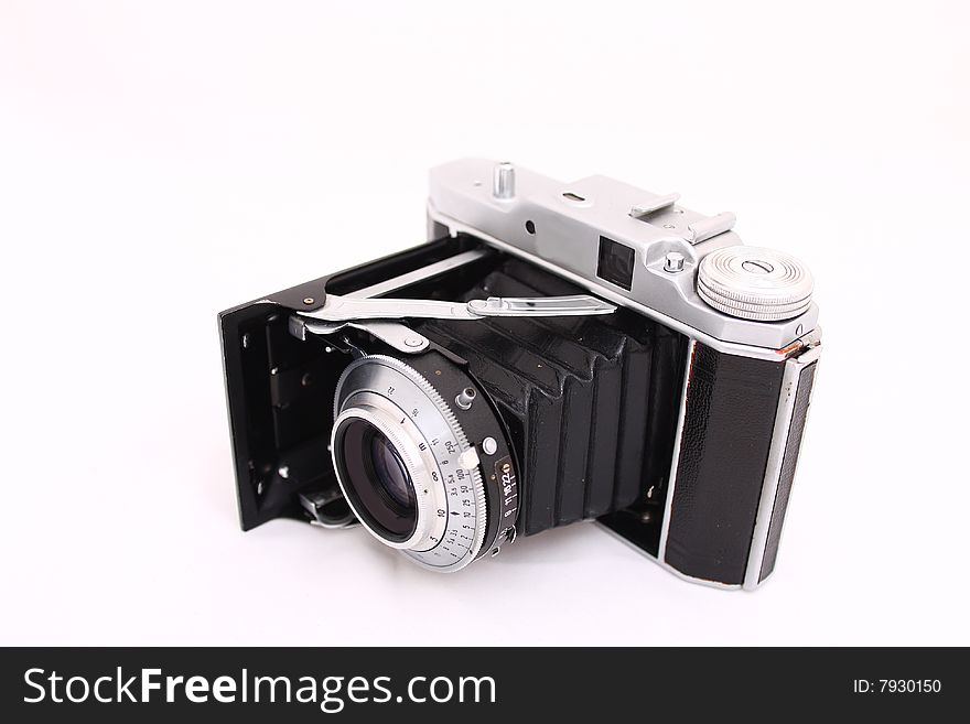 Antique folding camera on the whithe. Antique folding camera on the whithe