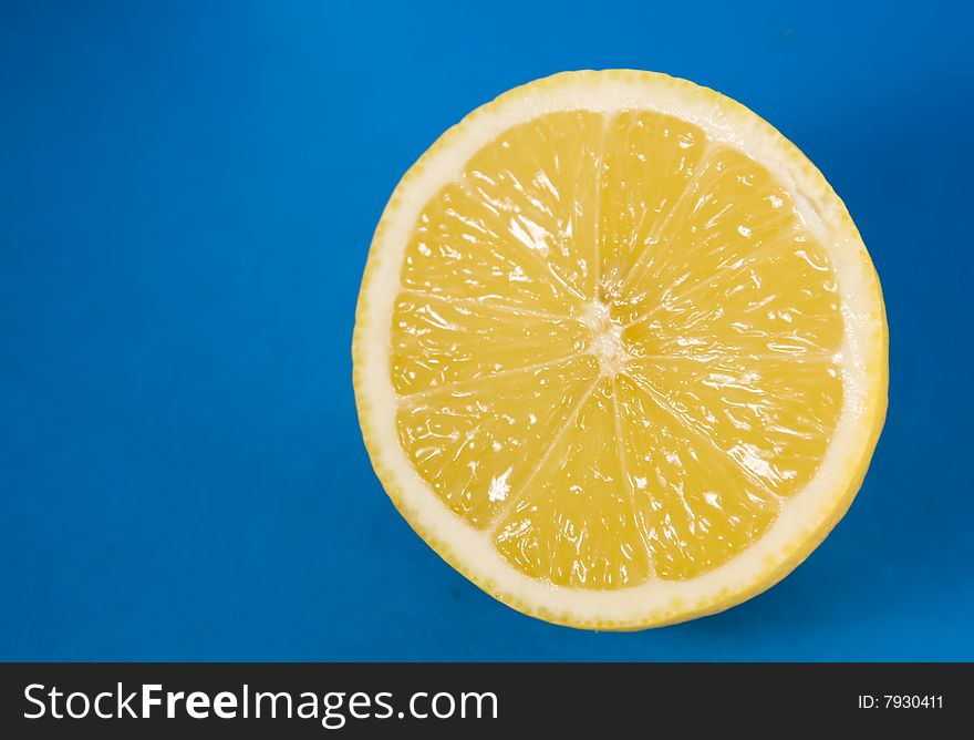 Juicy lemon isolated on blue background. Juicy lemon isolated on blue background