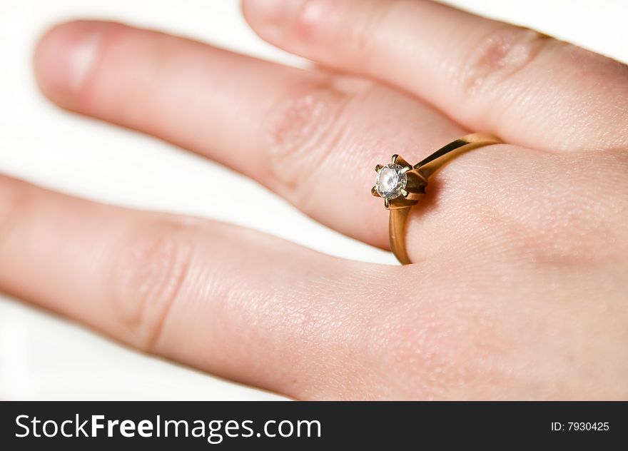 Engagement ring on woman's hand isolated on white