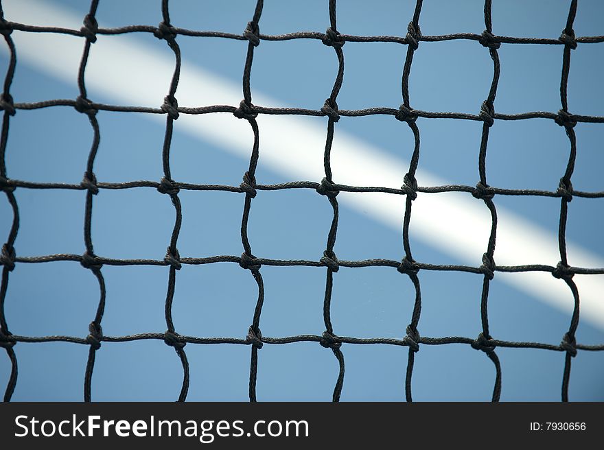 Tennis Net on blue court with line in background. Tennis Net on blue court with line in background