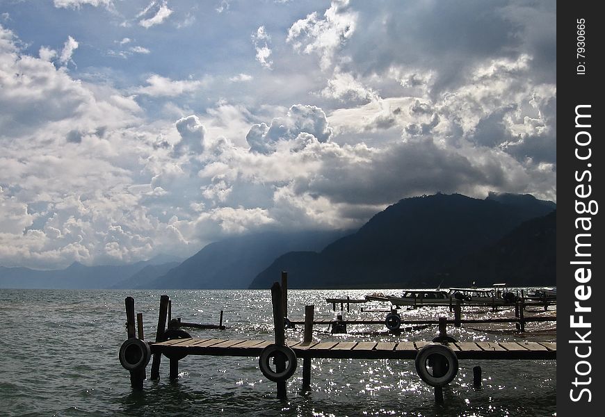 A dock on lake atitlan in guatemala with cloudy sky. A dock on lake atitlan in guatemala with cloudy sky