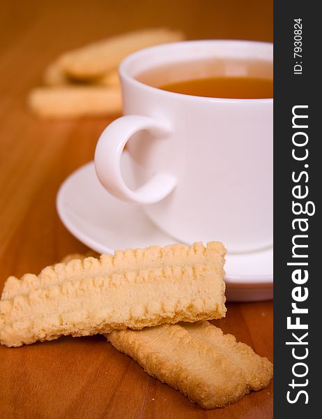 Cup of tea and some cookies on wooden table