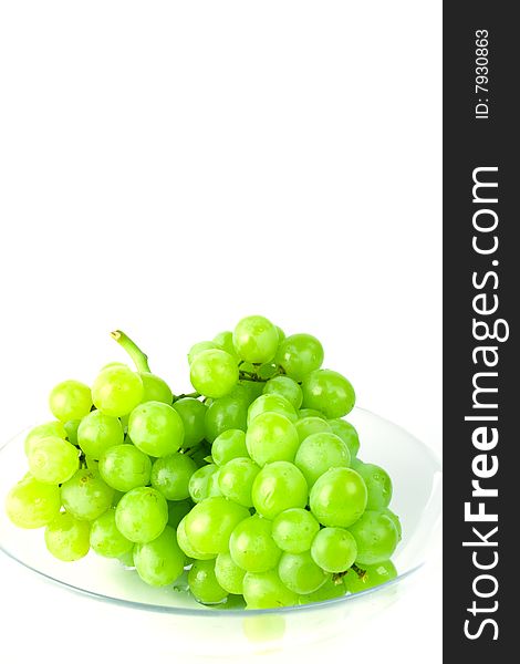 Green grapes in bowl on white background