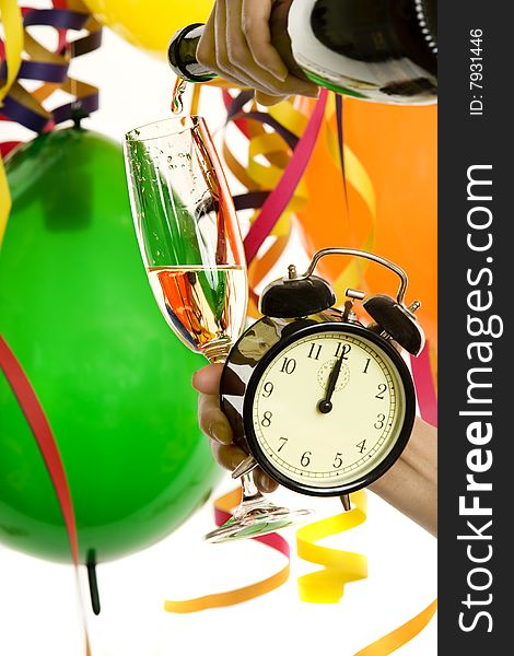 Turn of the year, New Year with champagne and clock, in the background balloons