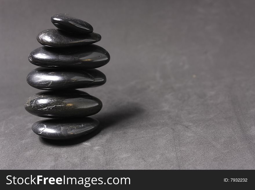 Stack of zen stones on gray background