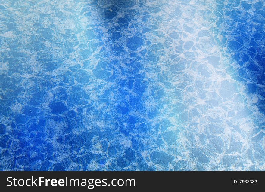 Partial sunlight shining on water ripples of pool