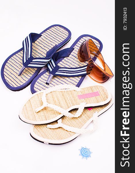 Male and female flip flops with sunglasses. Male and female flip flops with sunglasses