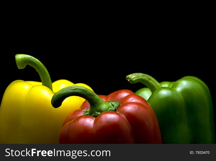 Yellow red and green pepper with black background. Yellow red and green pepper with black background