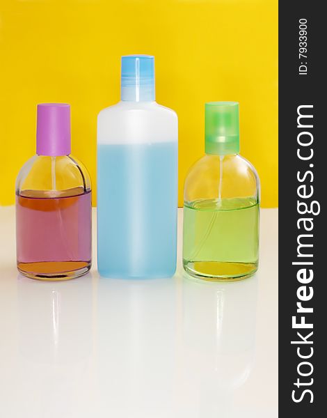 Perfumery bottles on a color background