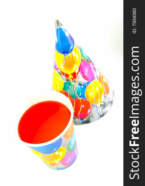 Party cups and hats isolated against a white background. Party cups and hats isolated against a white background