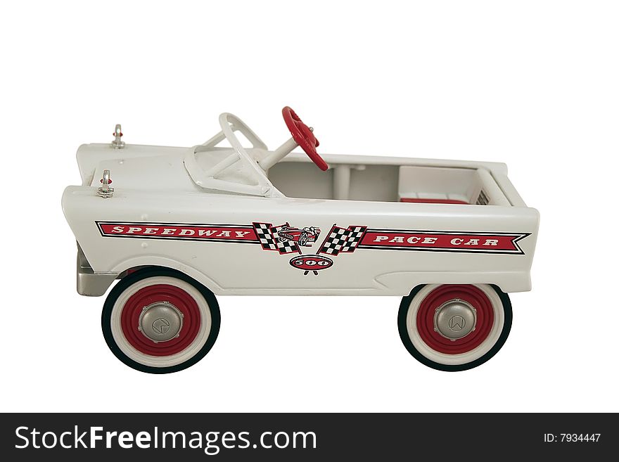 An antique pedal car replica of a speedway pace car. An antique pedal car replica of a speedway pace car