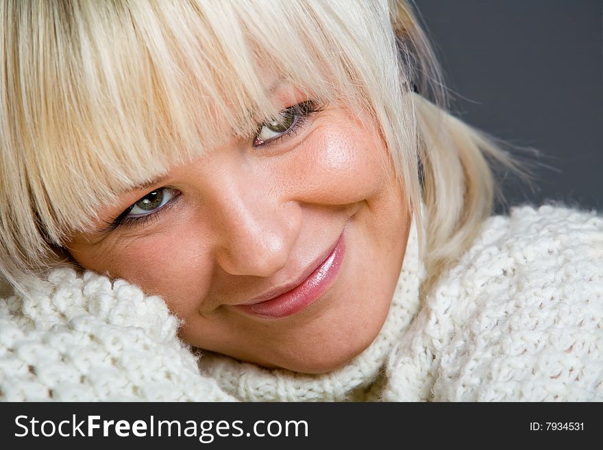 Close-up portrait of lovely blond woman indoors