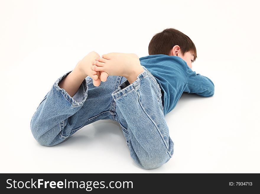 Adorable barefoot boy with toes in the air.