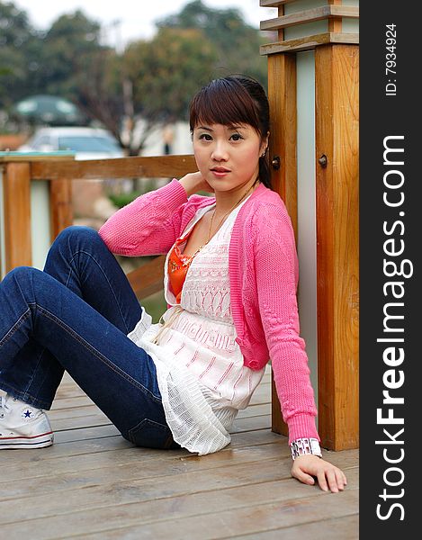 A  beautiful Young girl  Sit on the plank ,from china. A  beautiful Young girl  Sit on the plank ,from china