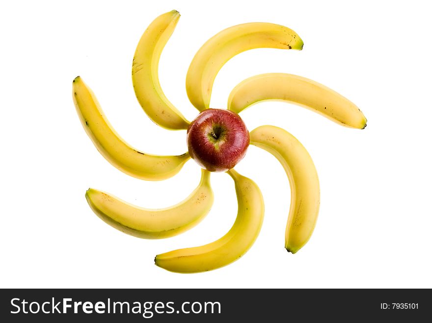 Composition from an apple and bananas in the form of the sun or flower on a white background. Composition from an apple and bananas in the form of the sun or flower on a white background