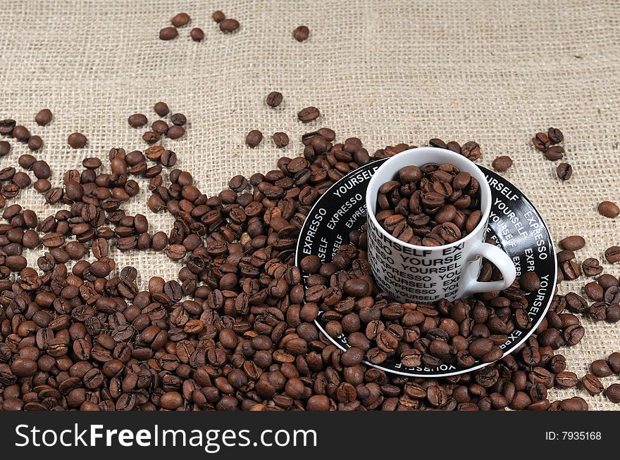 Coffee Beans and coffee cup on burlap