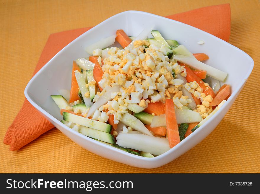 Boiled egg cubes with fresh vegetable on plate