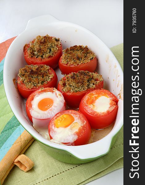 Baked filled tomatoes cut in half on plate