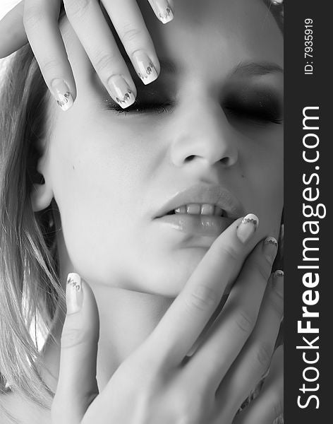 Portrait of a beautiful blond woman with manicure