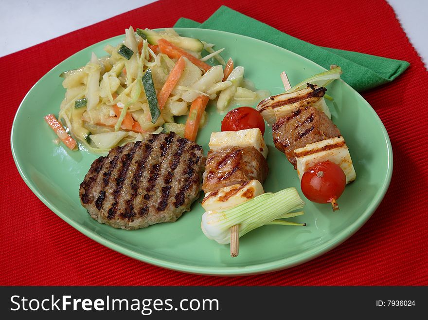 Meat, cherry tomato and green pepper skewers on grill