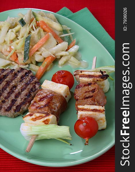 Meat, cherry tomato and green pepper skewers on grill