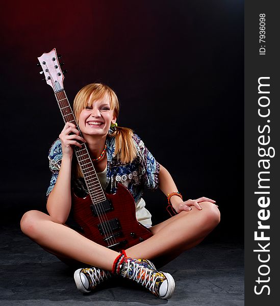 Portrait of a young woman with red electric guitar. Portrait of a young woman with red electric guitar