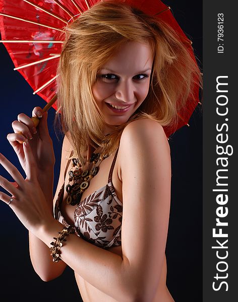 Portrait of a beautiful blond woman in lingerie with red parasol. Portrait of a beautiful blond woman in lingerie with red parasol