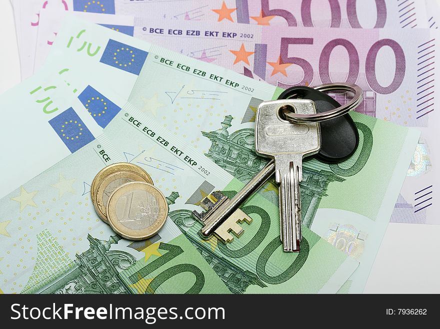 Euro banknotes with various coins and  bunch of keys