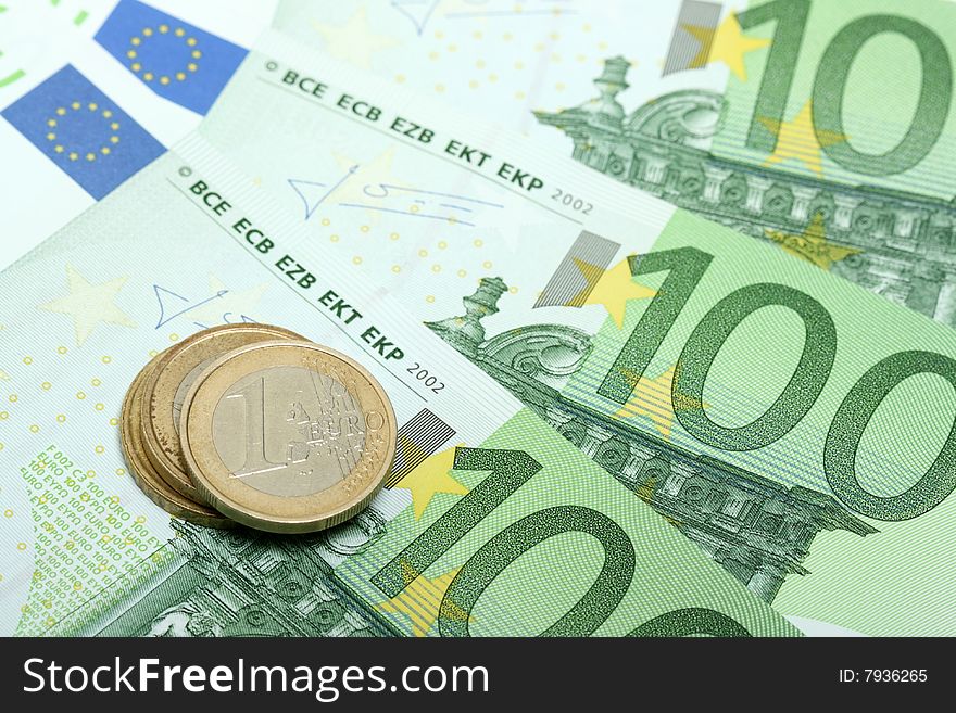 Euro banknotes with various coins