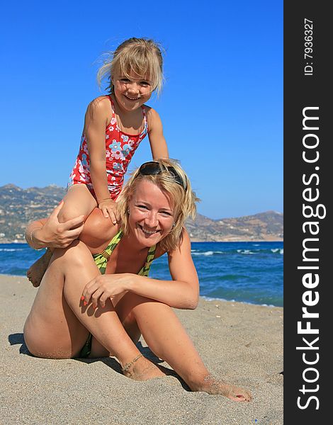 Happy mum with a daughter have a rest on the sea. Happy mum with a daughter have a rest on the sea