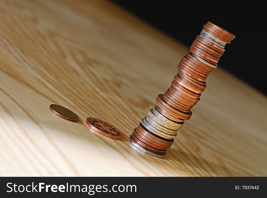 Close up of a stack of coins sliding