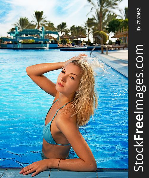 Beautiful blond woman relaxing in the pool