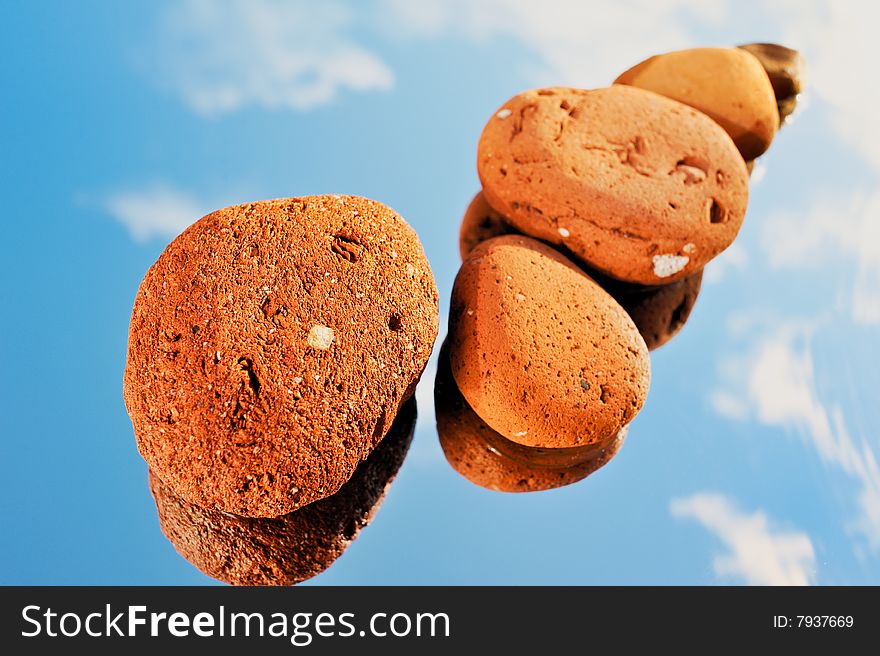 Red stones on a wet mirror and sky reflexion. Red stones on a wet mirror and sky reflexion