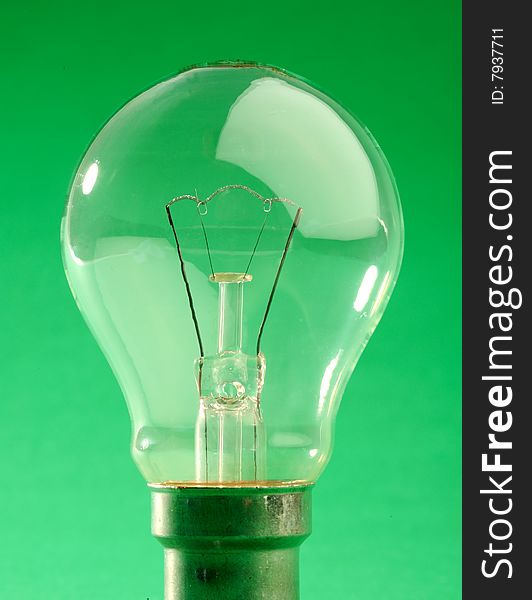 Old style Light bulb on a green background