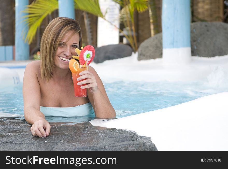 Beautiful Woman With Cocktail In A Swimming Pool