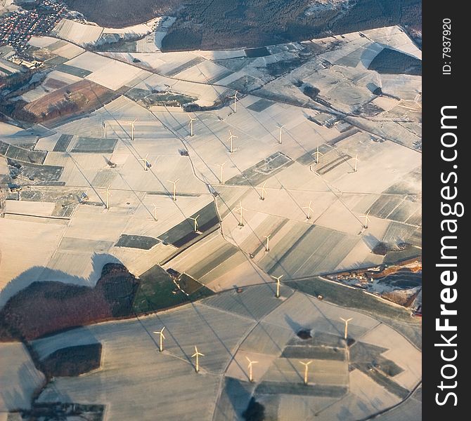 Windmills from the air im winter seasion with snow and sunset. Windmills from the air im winter seasion with snow and sunset