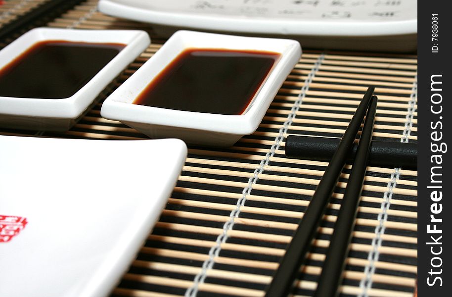 Japanese kitchen. Bamboo mat, dish and chopsticks