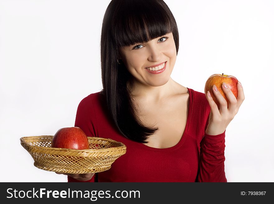 Beautiful young brunette woman holds red apples and smiles. Beautiful young brunette woman holds red apples and smiles